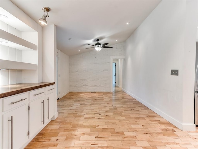unfurnished living room featuring vaulted ceiling, light wood finished floors, a ceiling fan, recessed lighting, and baseboards