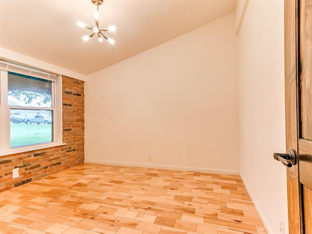 unfurnished room featuring a chandelier, lofted ceiling, and baseboards