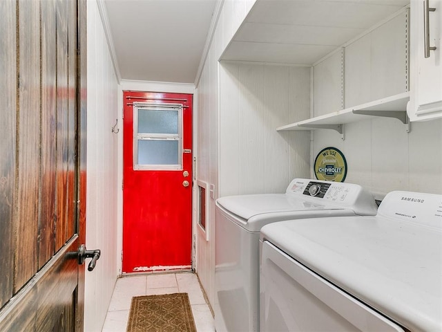 laundry room featuring washing machine and clothes dryer and light tile patterned flooring