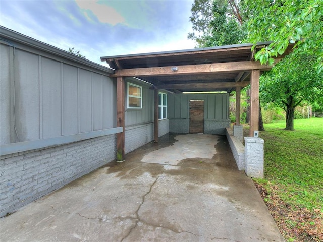 view of patio with a carport and driveway
