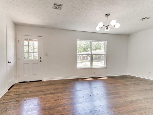 213 E Haddock St, Norman, OK 73069 - foyer featuring a chandelier, wood finished floors, a textured ceiling, and baseboards