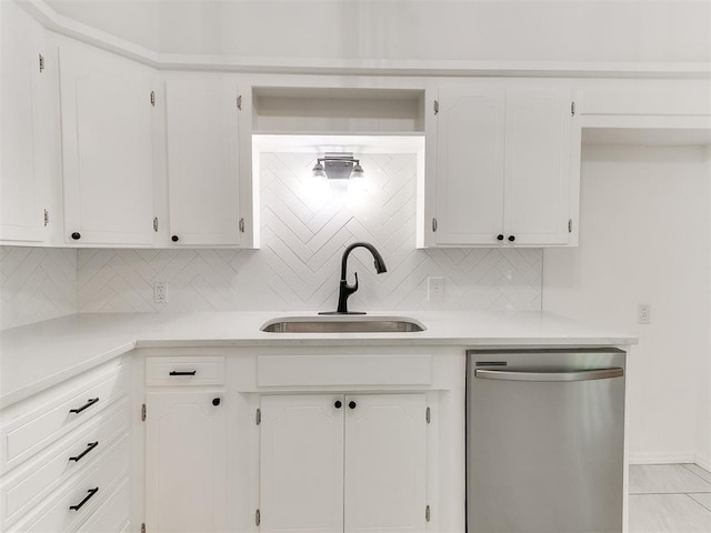 213 E Haddock St, Norman, OK 73069 - kitchen with stainless steel dishwasher, a sink, tasteful backsplash, and light countertops