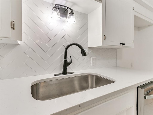 213 E Haddock St, Norman, OK 73069 - kitchen with light countertops, dishwasher, backsplash, white cabinets, and a sink