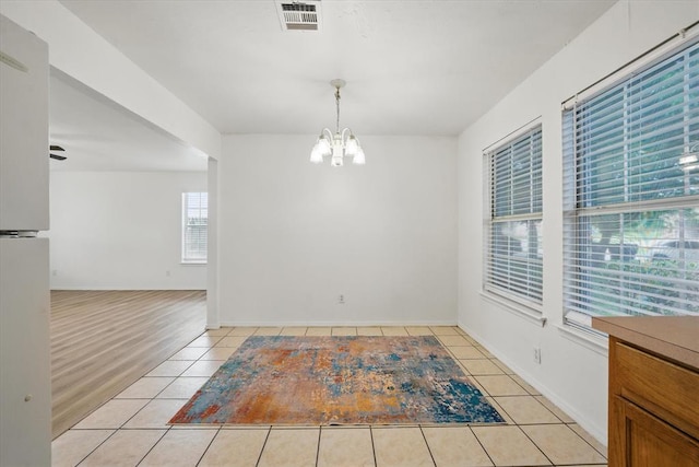 236 NW 91st St, Oklahoma City, OK 73114 - unfurnished dining area featuring a chandelier and light tile patterned floors