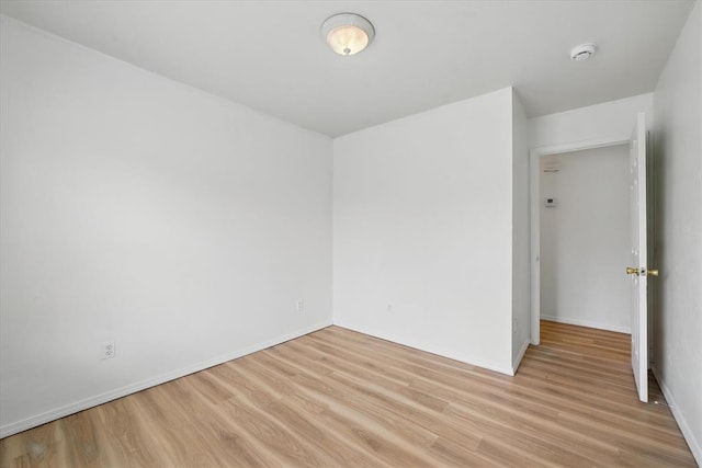236 NW 91st St, Oklahoma City, OK 73114 - unfurnished room featuring light wood-style floors, a smoke detector, and baseboards
