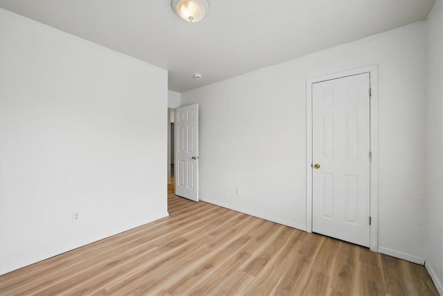 236 NW 91st St, Oklahoma City, OK 73114 - unfurnished bedroom featuring wood finished floors and baseboards