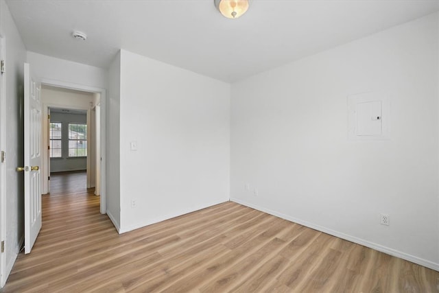 236 NW 91st St, Oklahoma City, OK 73114 - empty room with light wood finished floors, baseboards, a smoke detector, and electric panel