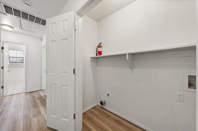 236 NW 91st St, Oklahoma City, OK 73114 - clothes washing area featuring electric dryer hookup, hookup for a washing machine, wood finished floors, and baseboards