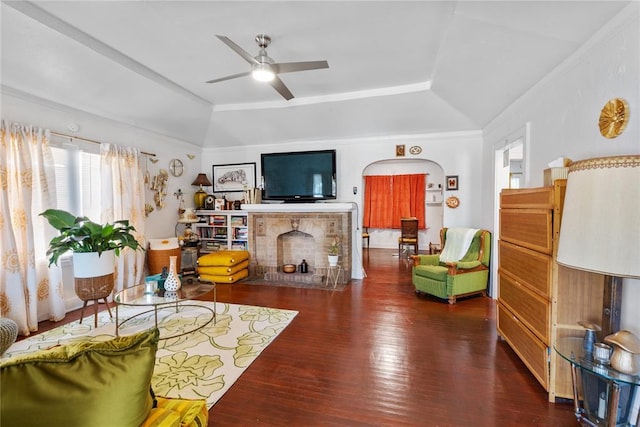 2017 NE 20th St, Oklahoma City, OK 73111 - living area featuring a tray ceiling, wood finished floors, a ceiling fan, a brick fireplace, and vaulted ceiling