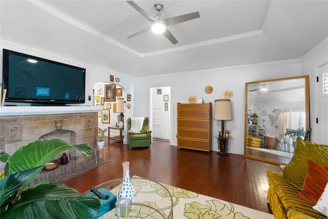 2017 NE 20th St, Oklahoma City, OK 73111 - living room with a raised ceiling, wood finished floors, ceiling fan, arched walkways, and crown molding