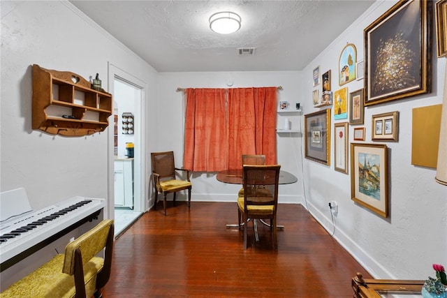 2017 NE 20th St, Oklahoma City, OK 73111 - living area featuring wood finished floors, ornamental molding, a textured ceiling, and baseboards
