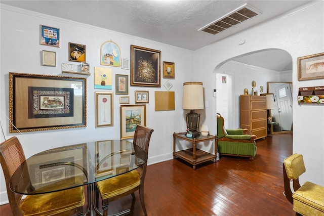 2017 NE 20th St, Oklahoma City, OK 73111 - dining space featuring arched walkways, wood finished floors, crown molding, and baseboards