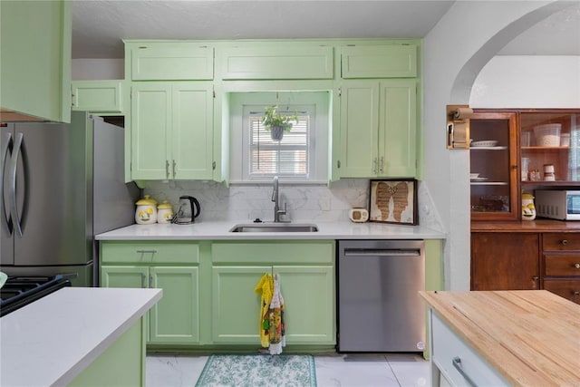 2017 NE 20th St, Oklahoma City, OK 73111 - kitchen with appliances with stainless steel finishes, green cabinetry, a sink, and light countertops