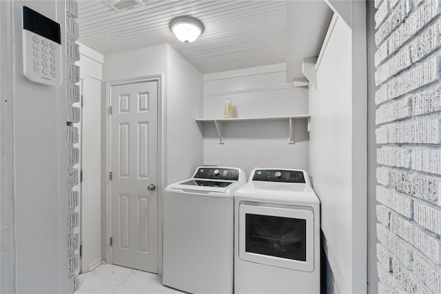 2017 NE 20th St, Oklahoma City, OK 73111 - washroom featuring washer and dryer and light marble finish floors