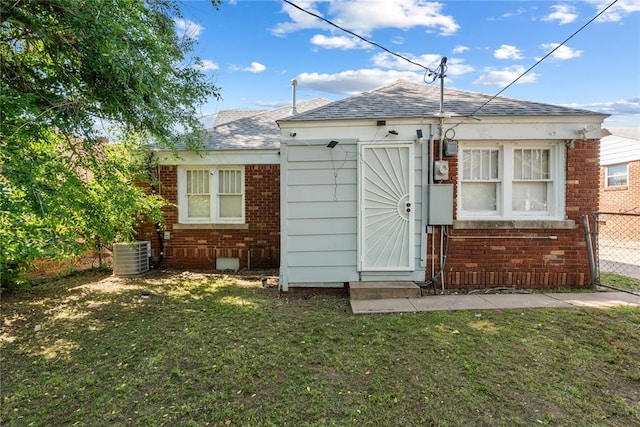 2017 NE 20th St, Oklahoma City, OK 73111 - back of house with roof with shingles, cooling unit, and brick siding