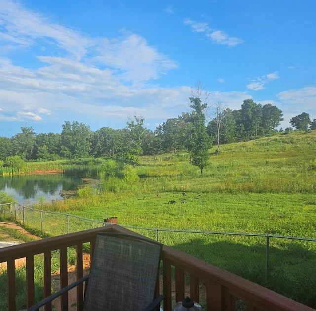 view of yard featuring fence and a water view