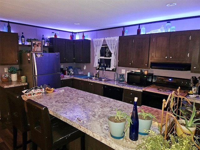 kitchen with black appliances, range hood, a sink, dark brown cabinetry, and recessed lighting