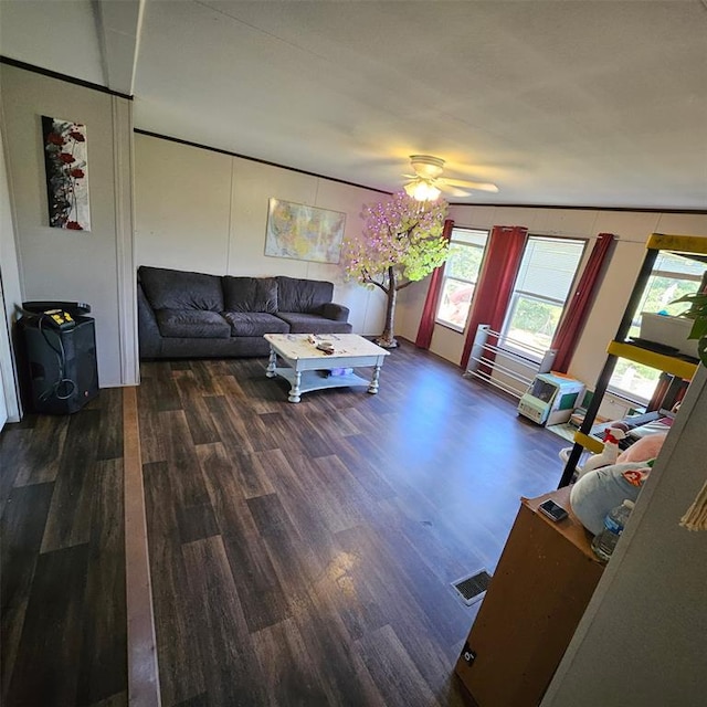 living area with wood finished floors and a ceiling fan