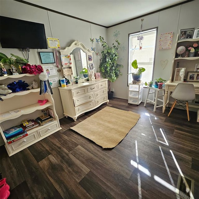 bedroom with ornamental molding and dark wood-type flooring