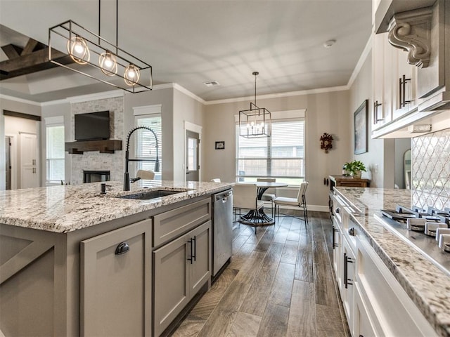 12125 SW 51st St, Mustang, OK 73064 - kitchen with a sink, stainless steel appliances, gray cabinetry, ornamental molding, and light stone countertops