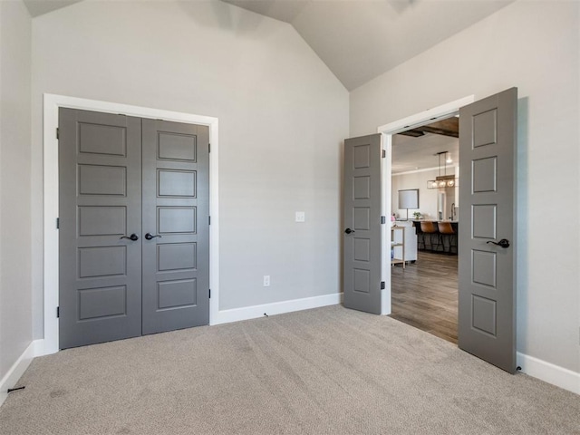 12125 SW 51st St, Mustang, OK 73064 - unfurnished bedroom with carpet floors, vaulted ceiling, and baseboards