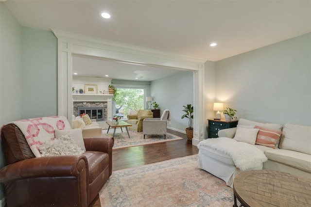 11412 Leaning Elm Rd, Oklahoma City, OK 73120 - living area with wood finished floors, a glass covered fireplace, baseboards, and recessed lighting