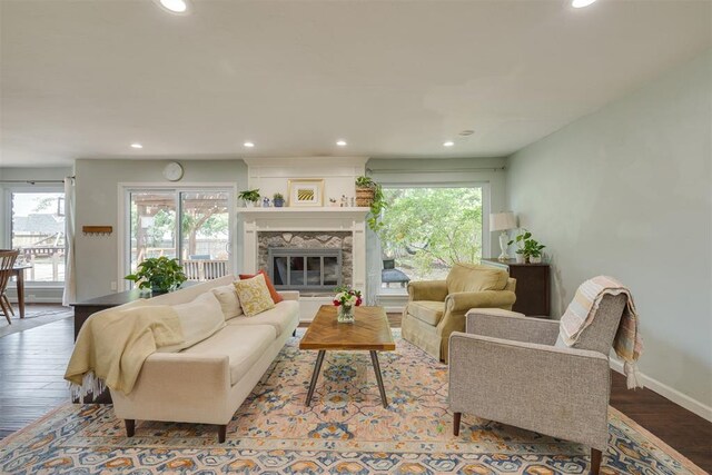 11412 Leaning Elm Rd, Oklahoma City, OK 73120 - living area with healthy amount of natural light, wood finished floors, recessed lighting, baseboards, and a glass covered fireplace