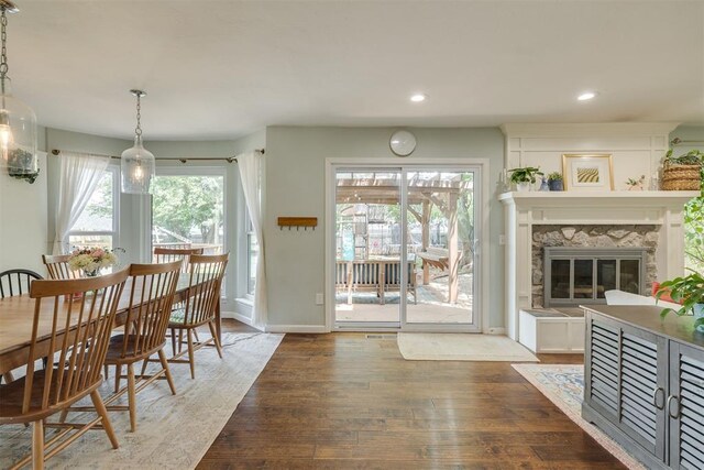 11412 Leaning Elm Rd, Oklahoma City, OK 73120 - dining area with wood-type flooring, recessed lighting, baseboards, and a high end fireplace