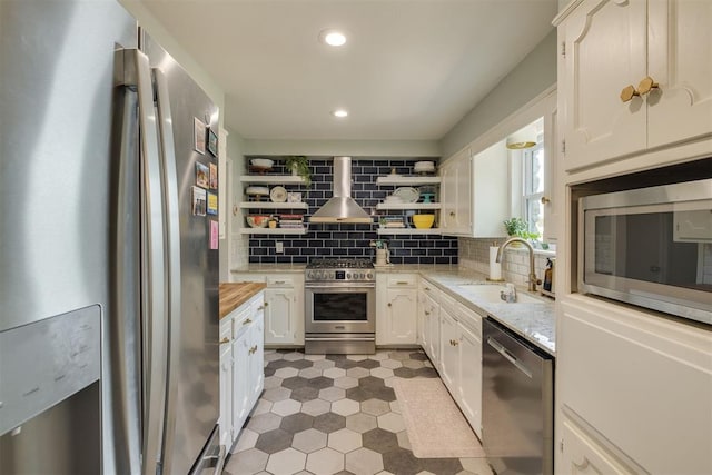 11412 Leaning Elm Rd, Oklahoma City, OK 73120 - kitchen with appliances with stainless steel finishes, a sink, open shelves, wall chimney exhaust hood, and backsplash