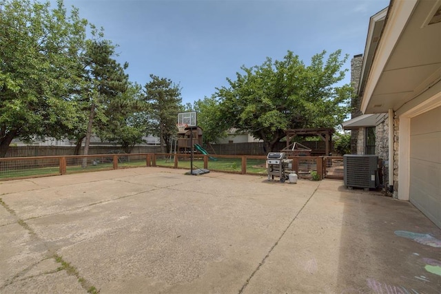 11412 Leaning Elm Rd, Oklahoma City, OK 73120 - view of patio featuring a playground, central AC, and a fenced backyard