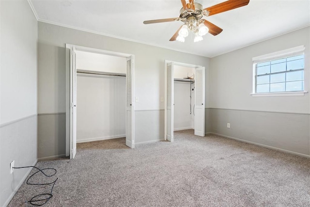 1500 S Railroad, Marlow, OK 73055 - unfurnished bedroom featuring multiple closets, crown molding, carpet, baseboards, and ceiling fan