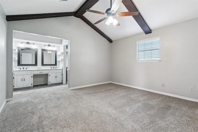 1500 S Railroad, Marlow, OK 73055 - unfurnished bedroom with light colored carpet, baseboards, connected bathroom, a sink, and a ceiling fan