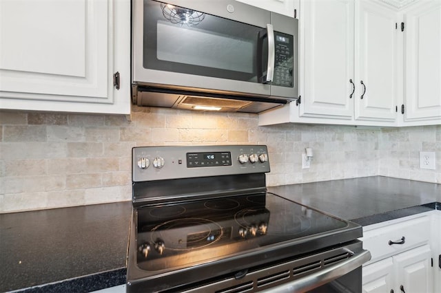 1500 S Railroad, Marlow, OK 73055 - kitchen with stainless steel appliances, white cabinets, dark countertops, and decorative backsplash