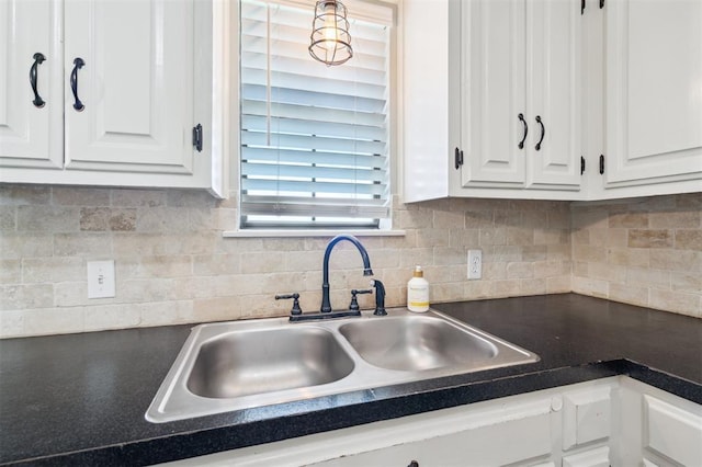 1500 S Railroad, Marlow, OK 73055 - kitchen with a sink, white cabinets, dark countertops, and decorative backsplash