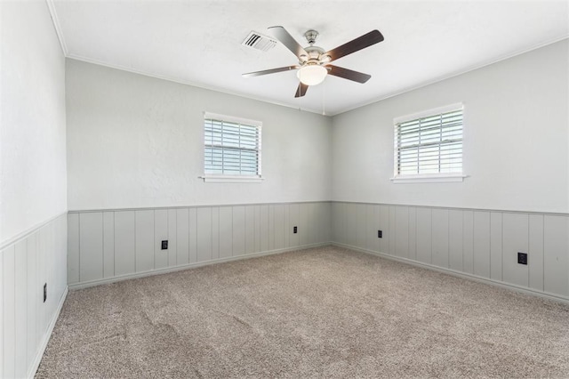 1500 S Railroad, Marlow, OK 73055 - carpeted spare room with plenty of natural light, ceiling fan, wainscoting, and ornamental molding