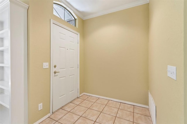 foyer entrance with crown molding, light tile patterned flooring, and baseboards