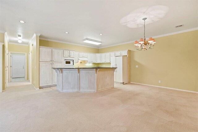 kitchen with white appliances, crown molding, a chandelier, light colored carpet, and baseboards