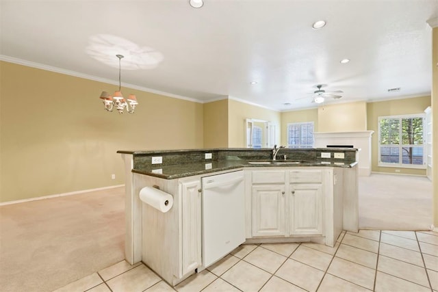 kitchen featuring white dishwasher, light colored carpet, a ceiling fan, a sink, and a chandelier