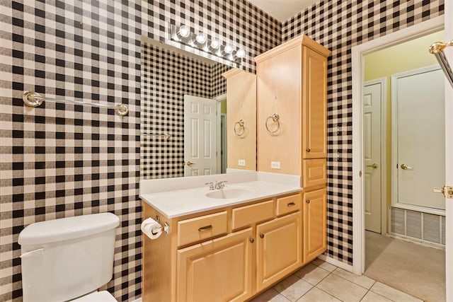 bathroom with wallpapered walls, tile patterned floors, toilet, and vanity