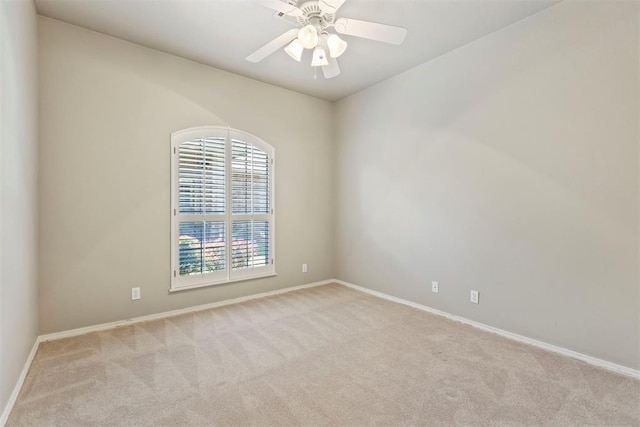 carpeted empty room with baseboards and ceiling fan