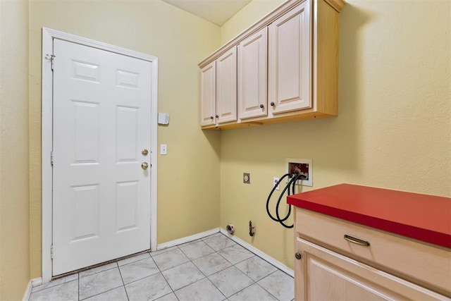 clothes washing area with hookup for a washing machine, cabinet space, gas dryer hookup, baseboards, and light tile patterned floors
