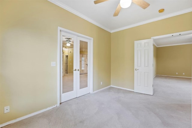 unfurnished bedroom with french doors, carpet floors, ornamental molding, and baseboards