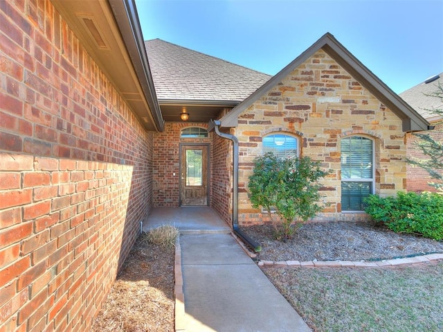 2408 Santa Monica St, Edmond, OK 73034 - entrance to property with a shingled roof and brick siding