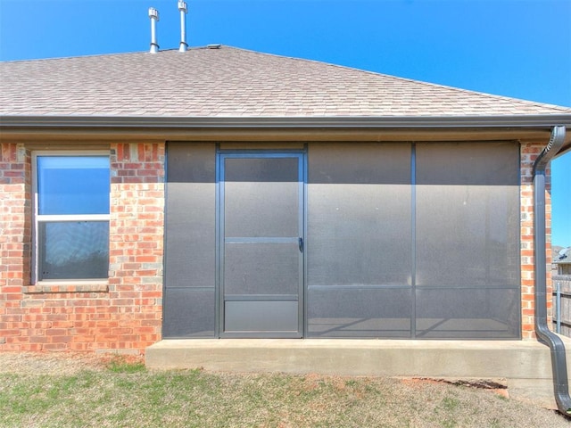 2408 Santa Monica St, Edmond, OK 73034 - back of house featuring a shingled roof and brick siding