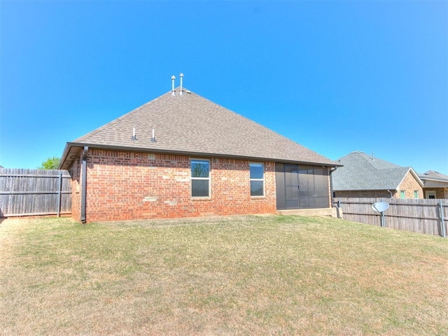 2408 Santa Monica St, Edmond, OK 73034 - back of house with brick siding, a shingled roof, and a sunroom