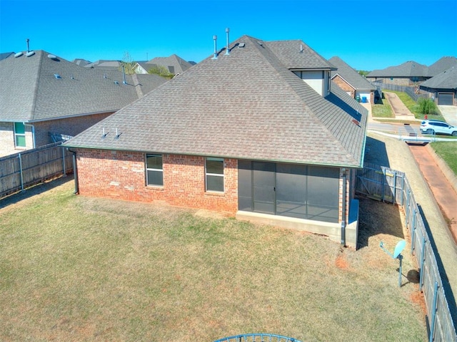 2408 Santa Monica St, Edmond, OK 73034 - back of property featuring a shingled roof, a sunroom, brick siding, and a residential view