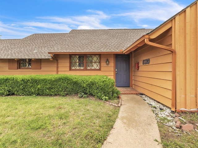 6120 Kingston Rd, Oklahoma City, OK 73122 - view of exterior entry featuring a shingled roof and a yard
