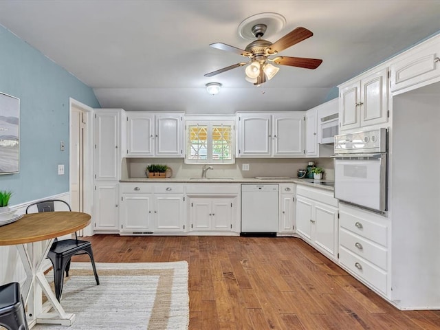 6120 Kingston Rd, Oklahoma City, OK 73122 - kitchen featuring white appliances, a sink, white cabinetry, ceiling fan, and light countertops