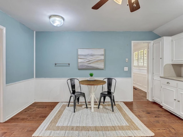 6120 Kingston Rd, Oklahoma City, OK 73122 - dining space with wood finished floors, ceiling fan, wainscoting, and vaulted ceiling