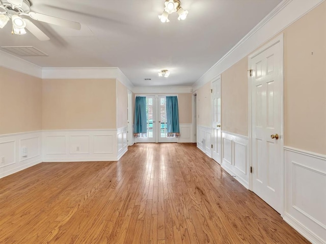 6120 Kingston Rd, Oklahoma City, OK 73122 - unfurnished room with a decorative wall, light wood finished floors, crown molding, french doors, and ceiling fan